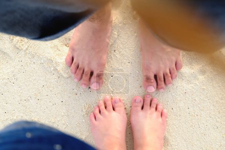Photo for Lover's feet on sand beach - Royalty Free Image