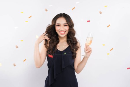 Téléchargez les photos : Young celebrating woman. Beautiful asian portrait isolated over studio background hold wine glass - en image libre de droit