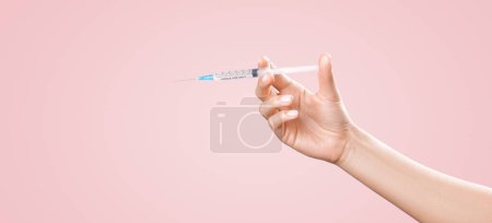 Photo for "Hand holding syringe with vaccine against corona virus." - Royalty Free Image