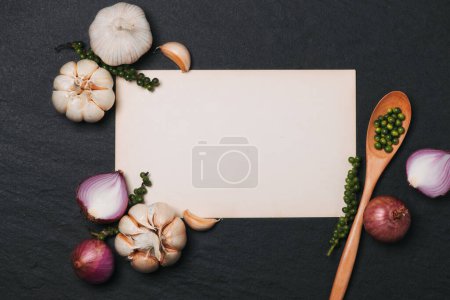 Photo for "Vegetable recipe. Open menu book with fresh herbs and spices on dark background" - Royalty Free Image