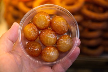 Photo for "Traditional Turkish  Lokma dessert fryied in oil and sweetened with syrup" - Royalty Free Image