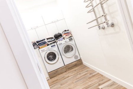 Photo for "Piles of clean clothes in laundry room" - Royalty Free Image