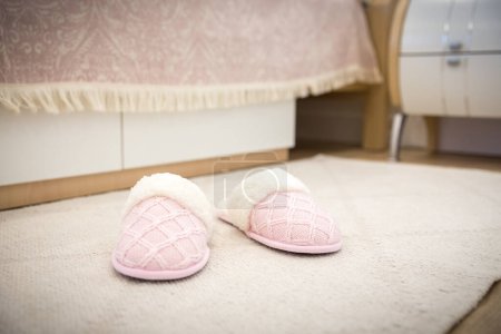Photo for "Bedroom in modern style with pink cozy soft slippers on floor" - Royalty Free Image