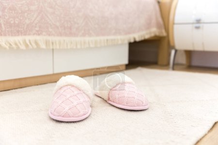 Photo for Bedroom in modern style with pink cozy soft slippers on floor - Royalty Free Image