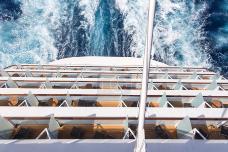 Photo for "Balconies on a Cruise ship, decks with wake or trail on ocean surface" - Royalty Free Image
