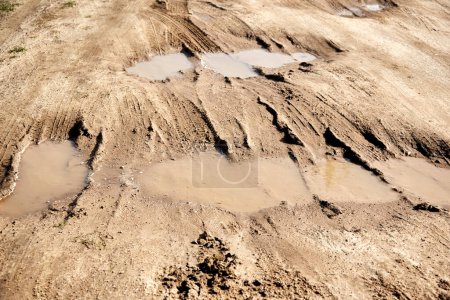 Photo for "many puddles on a dirt sandy road" - Royalty Free Image