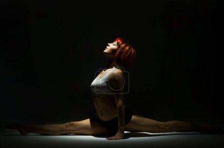 Photo for "Fit woman doing the splits" - Royalty Free Image