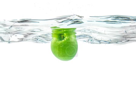 Photo for Water splash. Green apple under water. Air bubble and transparent water. - Royalty Free Image