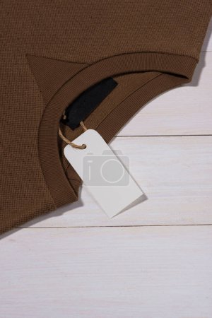 Photo for "Shirt price tag. Rectangular tag is attached to a sweater" - Royalty Free Image