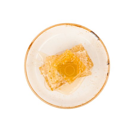 Photo for "Cut comb honey on plate isolated" - Royalty Free Image