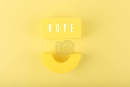Photo for Spiritual optimistic minimal concept of hope with smile against bright yellow background - Royalty Free Image