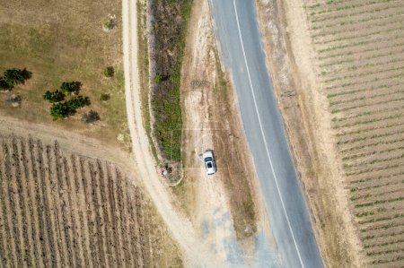Photo for White Car Beside Roads And Country Fields - Royalty Free Image