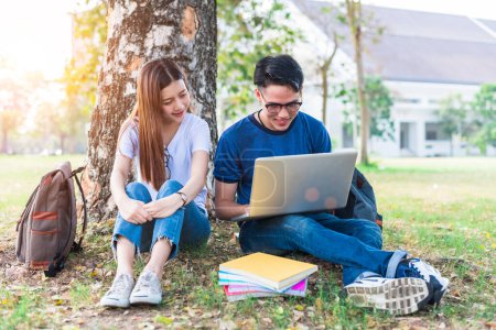 Photo for Two Asian young college people discussing about homework and final examination for testing with laptop. Education and Friendship concept. Happiness and Learning concept. Lovers and Friend theme. - Royalty Free Image