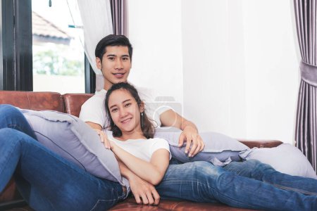 Photo for Sweet free time together. Happy beautiful lovers spending weekend together on couch or sofa indoors at home, Relaxing and Enjoying on couple concept in holidays - Royalty Free Image
