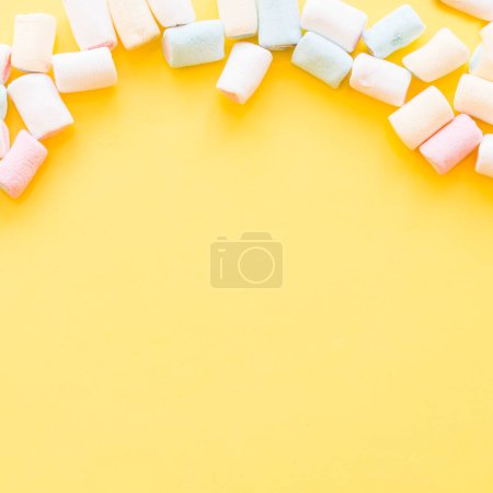 Téléchargez les photos : "marshmallows doux bord fond jaune. Photo de haute qualité" - en image libre de droit