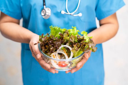 Photo for Nutritionist doctor holding various healthy fresh vegetables for patient. - Royalty Free Image