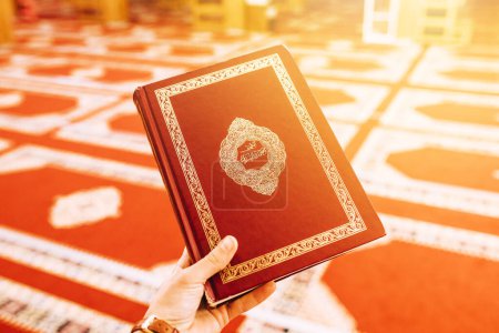Photo for Hand holding quran in mosque - Royalty Free Image
