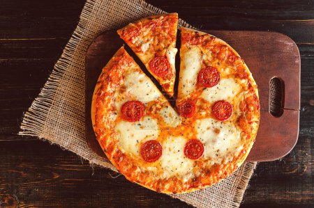 Photo for "Hot Homemade Pepperoni Pizza Ready to Eat" - Royalty Free Image