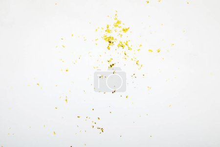 Téléchargez les photos : "Paillettes dorées renversées sur table blanche abstraite" - en image libre de droit