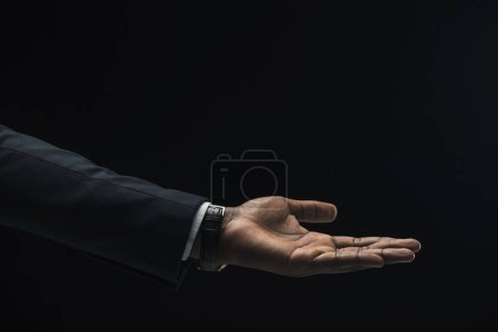 Foto de Hombre de negocios mano sobre fondo negro - Imagen libre de derechos