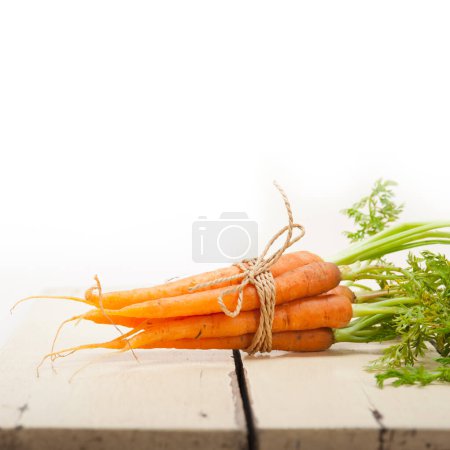 Photo for "baby carrots bunch tied with rope" - Royalty Free Image