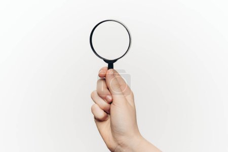 Photo for Magnifier in hand tool search lcd light background - Royalty Free Image