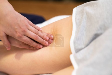 Photo for Medical massage at the leg in a physiotherapy center. - Royalty Free Image