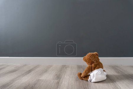 Photo for Teddy bear sits near wall - Royalty Free Image