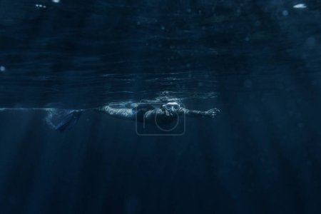 Photo for Man swimming underwater surface. - Royalty Free Image