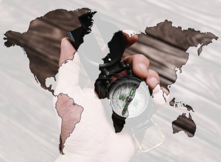 Photo for Double exposure of compass in a hand with map of world - Royalty Free Image
