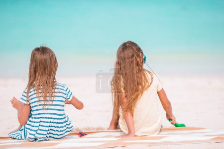 Photo for Two kids making sand castle and having fun at tropical beach - Royalty Free Image