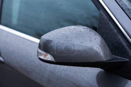 Photo for Rear view mirror of car. Wet from drops of water - Royalty Free Image