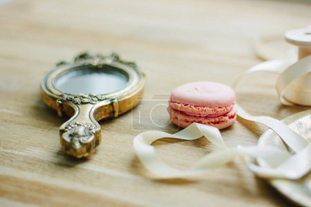 Photo for "Hand mirror and macaroon as wedding decoration" - Royalty Free Image