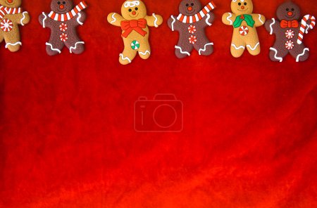 Photo for "Christmas food. Gingerbread man cookies in Christmas setting. Xmas red background top view retro modern design" - Royalty Free Image