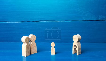 Photo for "Child stands between his biological mother and foster family. Surrogate pregnancy concept. Birth of a child for further adoption by childless family. Inability to have kids, infertility." - Royalty Free Image