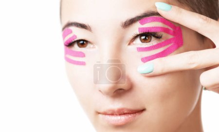 Photo for "Woman with lifting kinesiology tape on eyelid." - Royalty Free Image