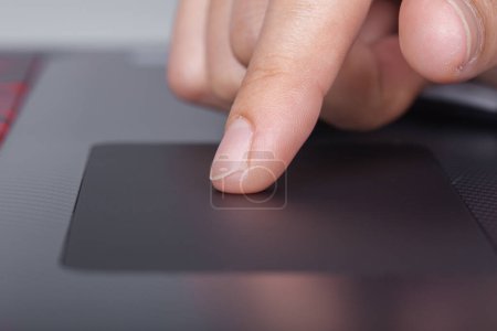 Photo for "business hand working on a laptop touchpad" - Royalty Free Image
