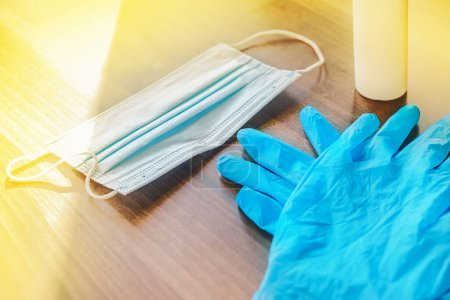 Photo for Protective latex gloves and a medical mask on the table background - Royalty Free Image