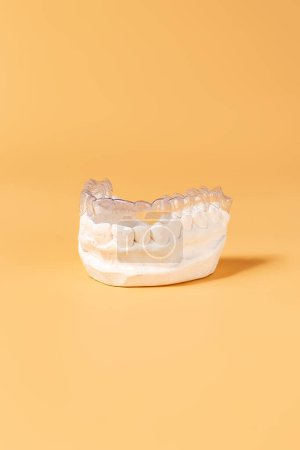 Photo for "Close-up individual tooth tray Orthodontic dental theme. In hand Invisible braces" - Royalty Free Image
