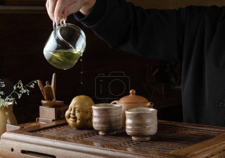 Téléchargez les photos : Cérémonie du thé mains de l'homme et de la femme pour verser le thé - en image libre de droit