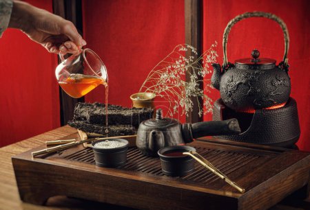 Photo for Tea table with instruments teapots cups pancake and tea Shen Puer - Royalty Free Image