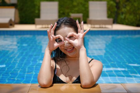 Photo for Beautiful young asian woman in pool relaxing - Royalty Free Image