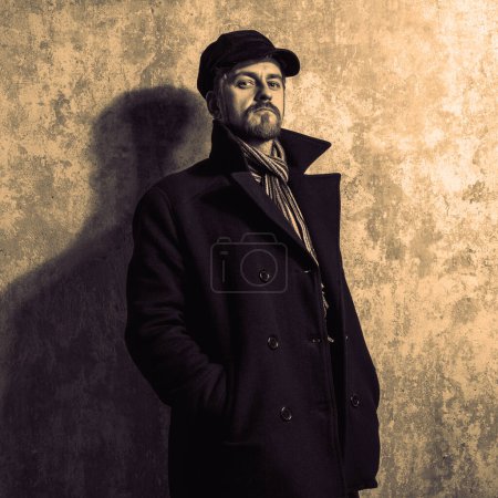 Photo for Man with grungy blond hair  in  stylish black trench coat - Royalty Free Image