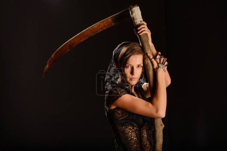 Photo for Girl in a black lace smock with scythe of death. - Royalty Free Image
