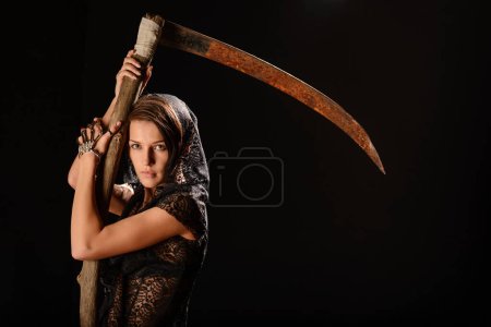 Photo for Girl in a black lace smock with scythe of death. - Royalty Free Image