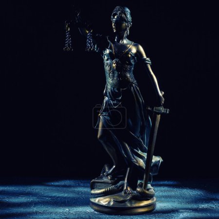 Photo for Themis statuette stands on the old vintage stone table. - Royalty Free Image