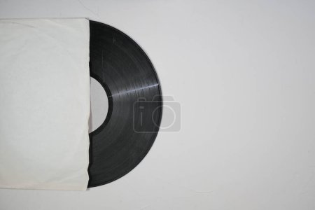 Photo for Old vinyl record in paper case on white marble background - Royalty Free Image