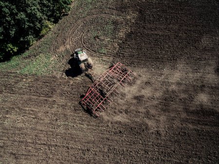 Photo for Tractor plowing field, top view - Royalty Free Image