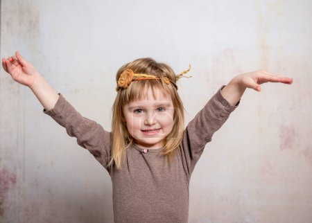 Photo for Pretty little girl with headband dancing - Royalty Free Image