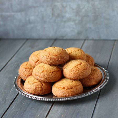 Photo for "Dutch almond cookies called ""bitterkoekjes"" on metal plate" - Royalty Free Image